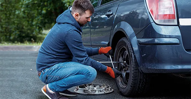Roadside technician changing a flat tire